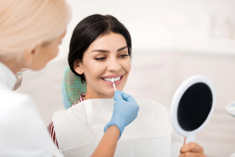 dental implants vs veneers, woman deciding which is the best dental procedure
