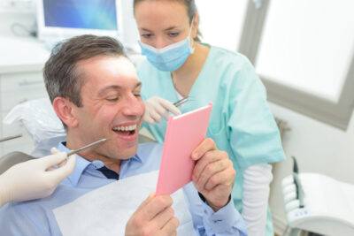 dental implants and dental bridges, patient is happy with dental procedure