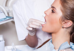 female patient receiving consultation and dentist is examining her teeth for dental restorations 