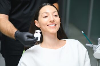 young woman selecting color of veneers