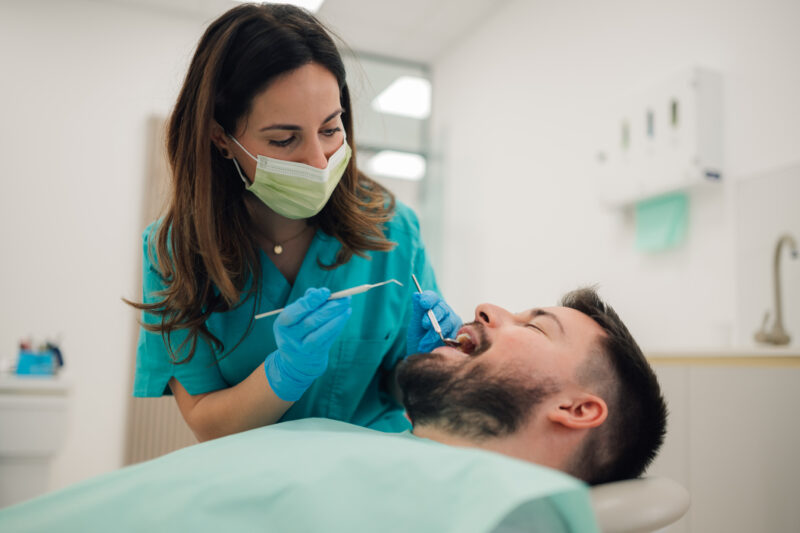 dentist checking patient for early signs of gum disease